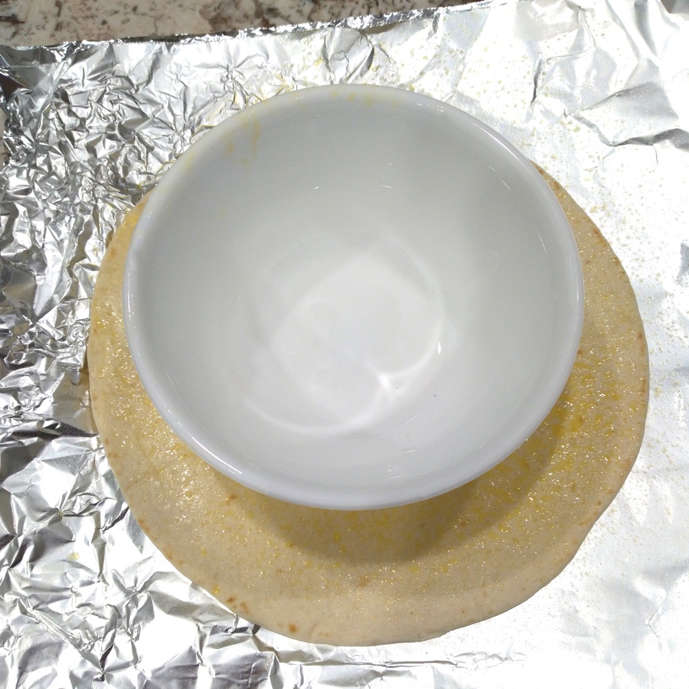 Spray the tortilla with vegetable oil on both sides and place in the center of the foil. 