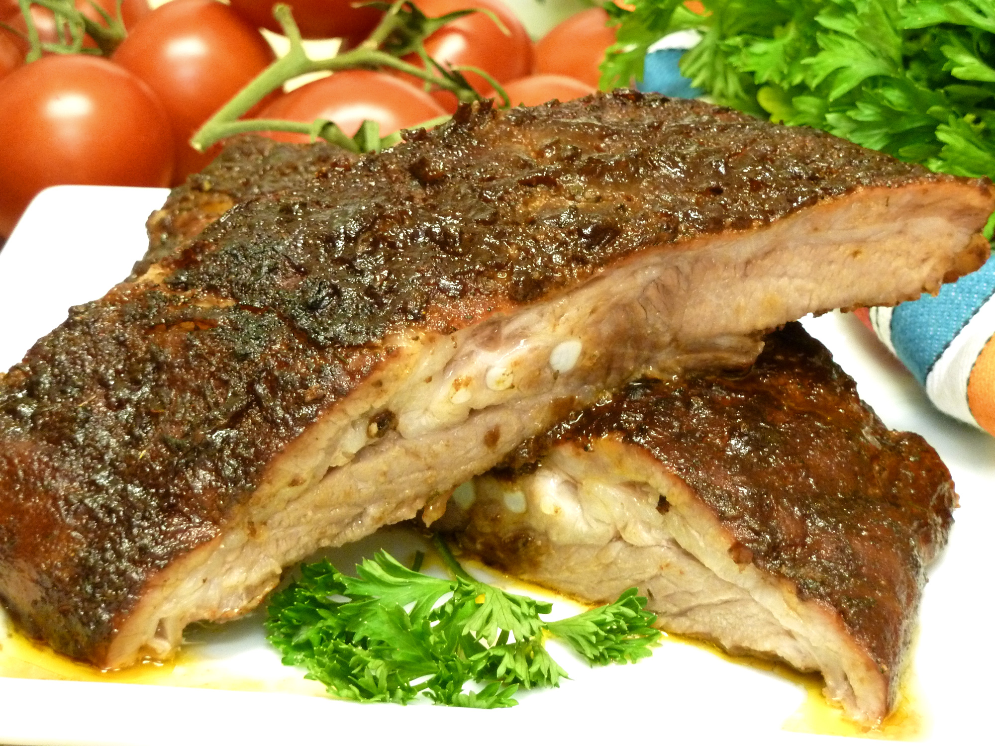 Homemade pomegranate BBQ sauce tops easy spareribs made in the oven.