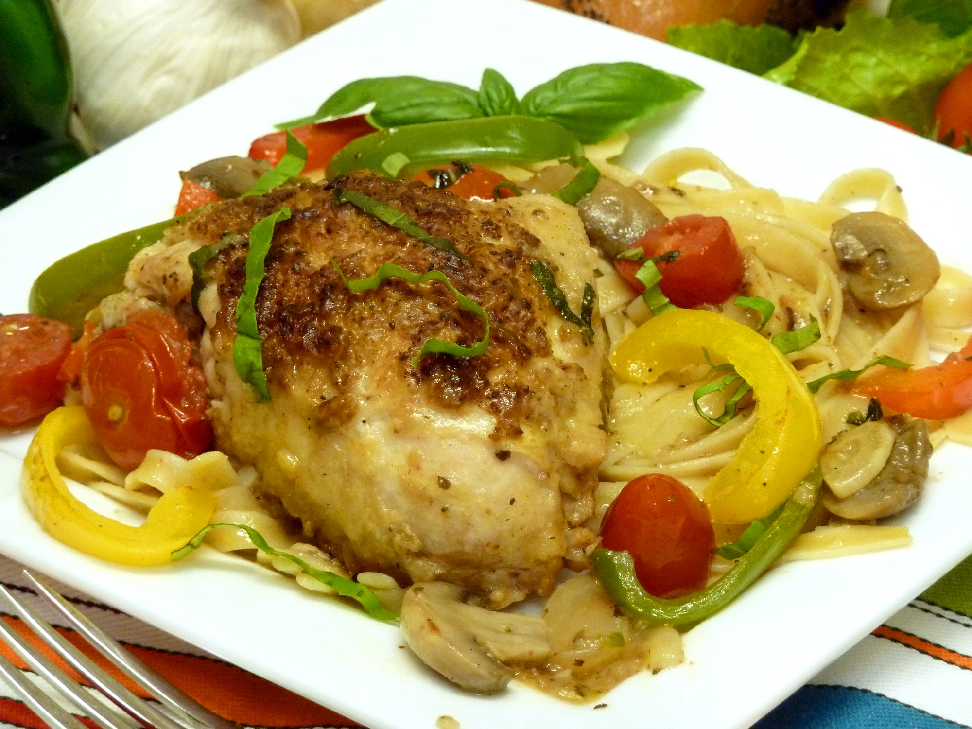 Tender chicken cacciatora celebrates the Italian flavors of chicken, oregano, basil, garlic, and fresh vegetables over pasta.