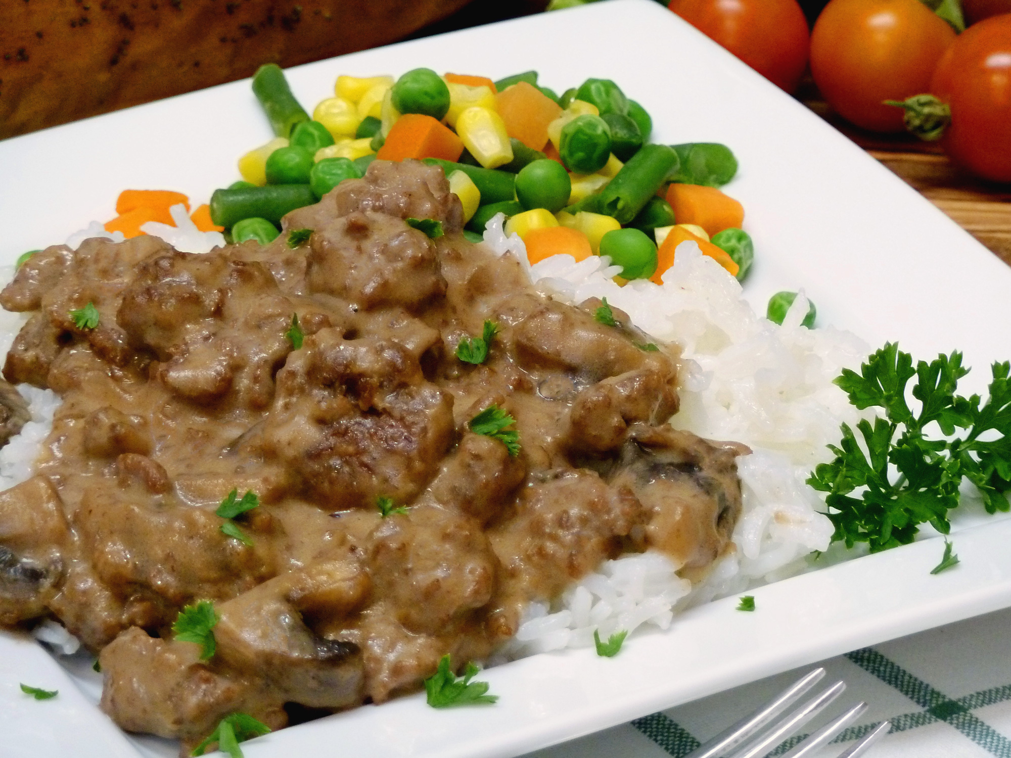 Ground beef, sausage, and mushrooms make a chunky stroganoff perfect over rice or noodles.