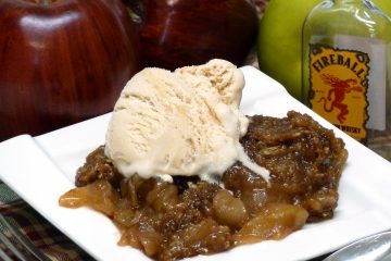 Luscious apple crisp is flavored with spicy Fireball Cinnamon Whiskey.