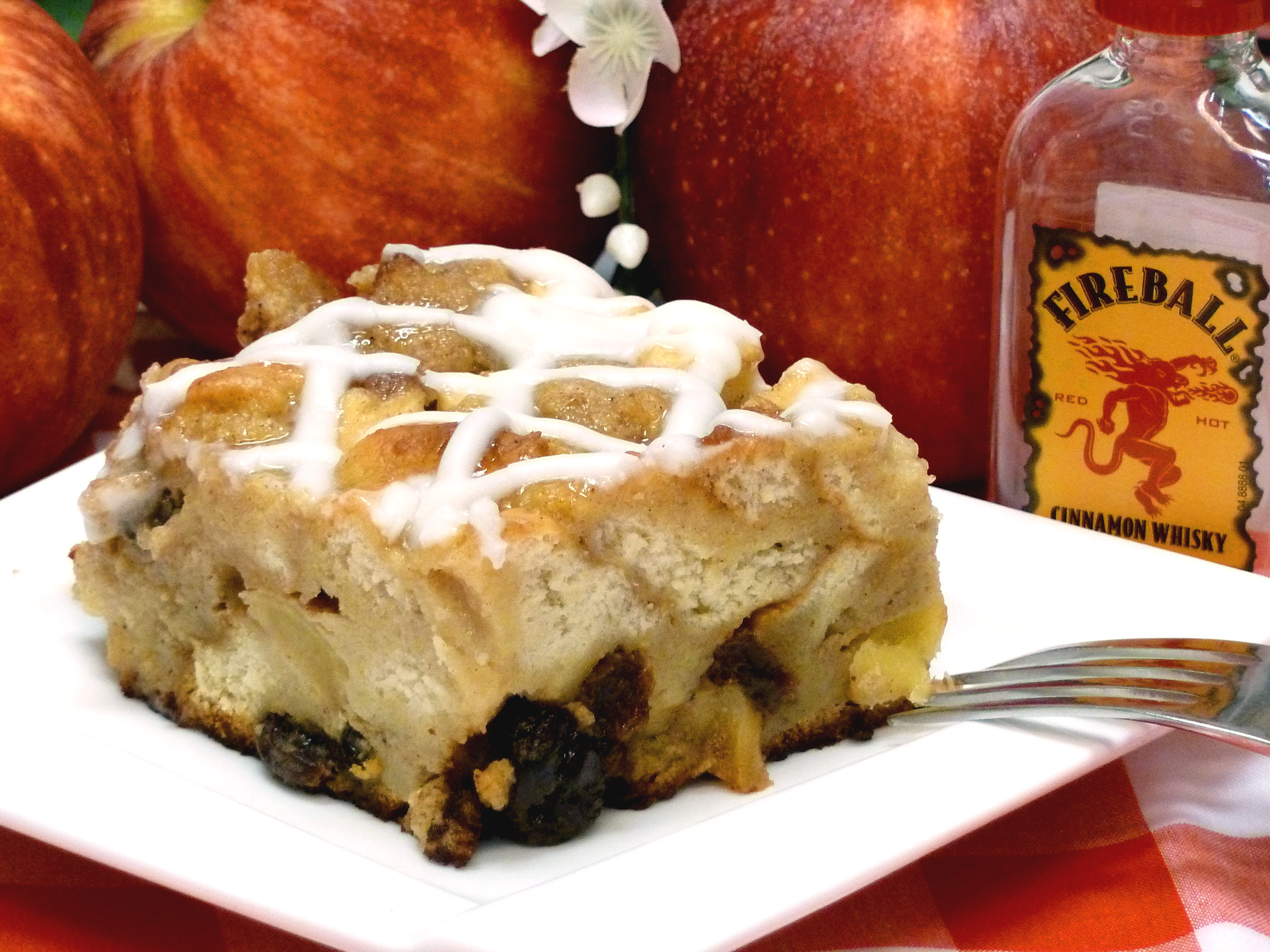 Fireball cinnamon whiskey goes great with apples and raisins to level up old-fashioned bread pudding.