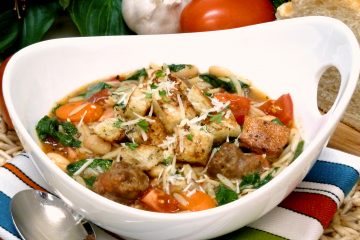 Italian sausage soup is loaded with fresh vegetables, white beans, and orzo for a nostalgic meal in a bowl.