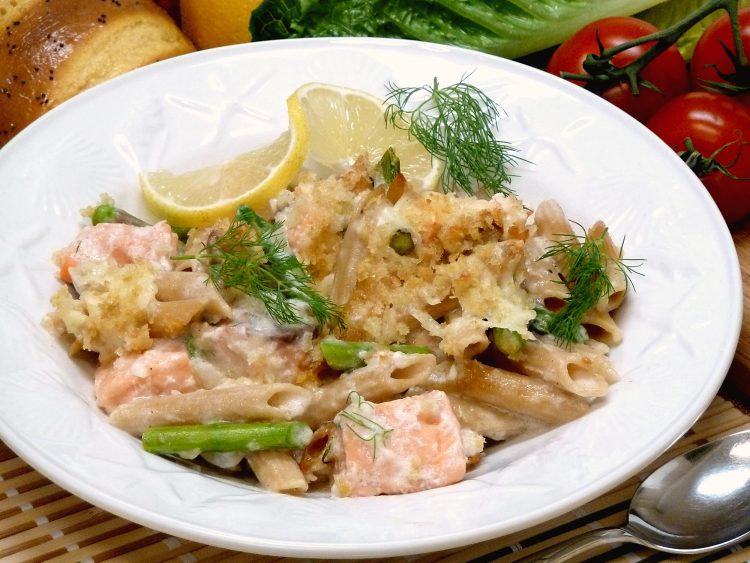 Salmon Asiago Casserole is loaded with asparagus and topped with a cheesy alfredo seafood sauce.