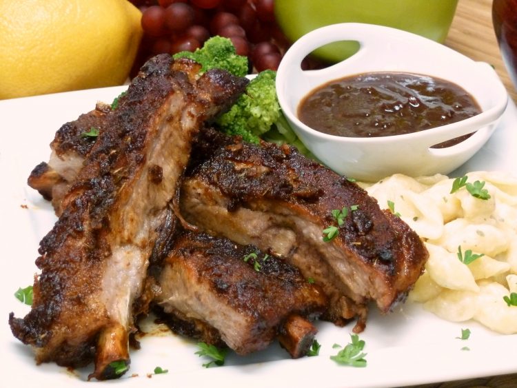 Juicy sweet and sour spareribs are baked in the oven.
