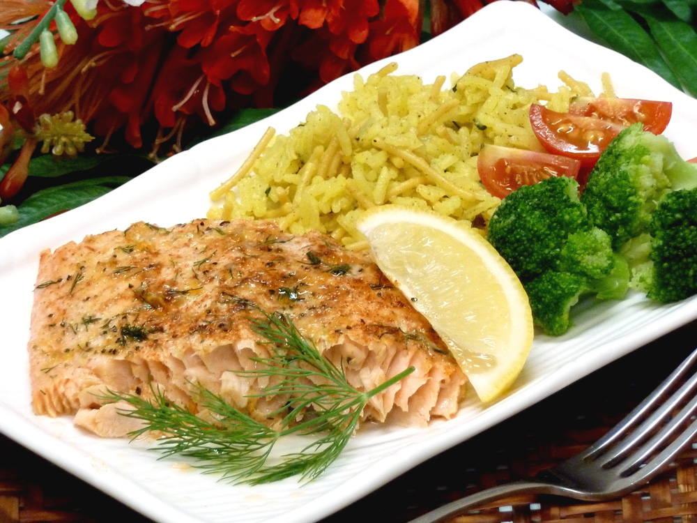 Deliciously moist salmon is seasoned with butter, herbs, lemon, and Parmesan cheese.