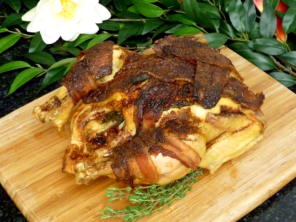 Bacon Wrapped Chicken Recipe: Bacon keeps this whole roasted chicken moist and juicy.